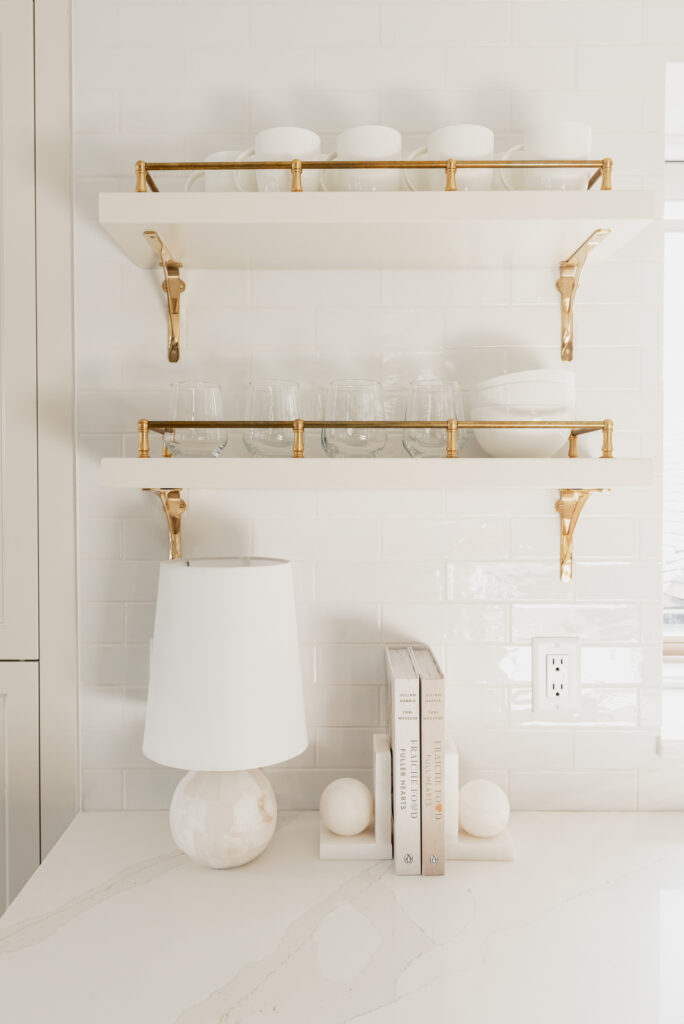 traditional brass shelves cream kitchen subway tile