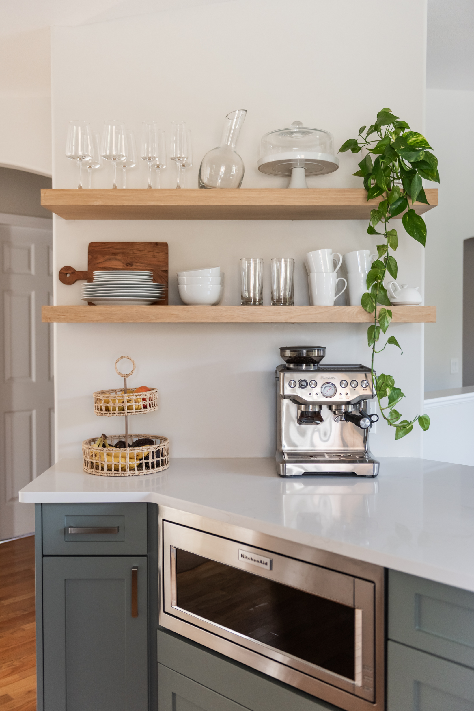 Thoughtfully styled kitchen shelves that soften the space while maintaining function and flow.