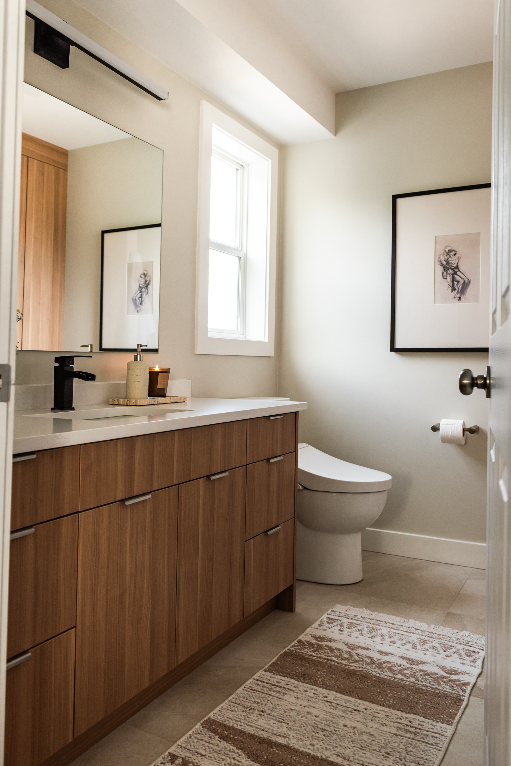 Ensuite bathroom featuring large tiled walk in shower with built in bench, oversized niche, and rainfall shower head.