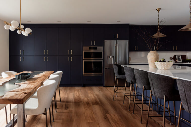 Custom navy pantry wall with floor-to-ceiling cabinetry for high-function family kitchen storage