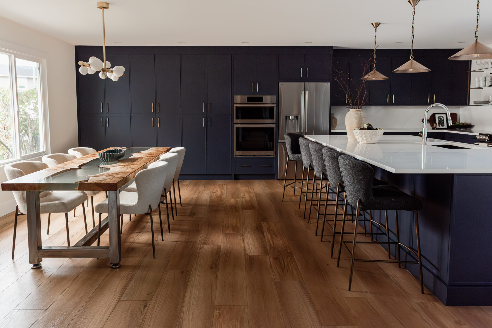 Custom navy pantry wall with floor-to-ceiling cabinetry for high-function family kitchen storage