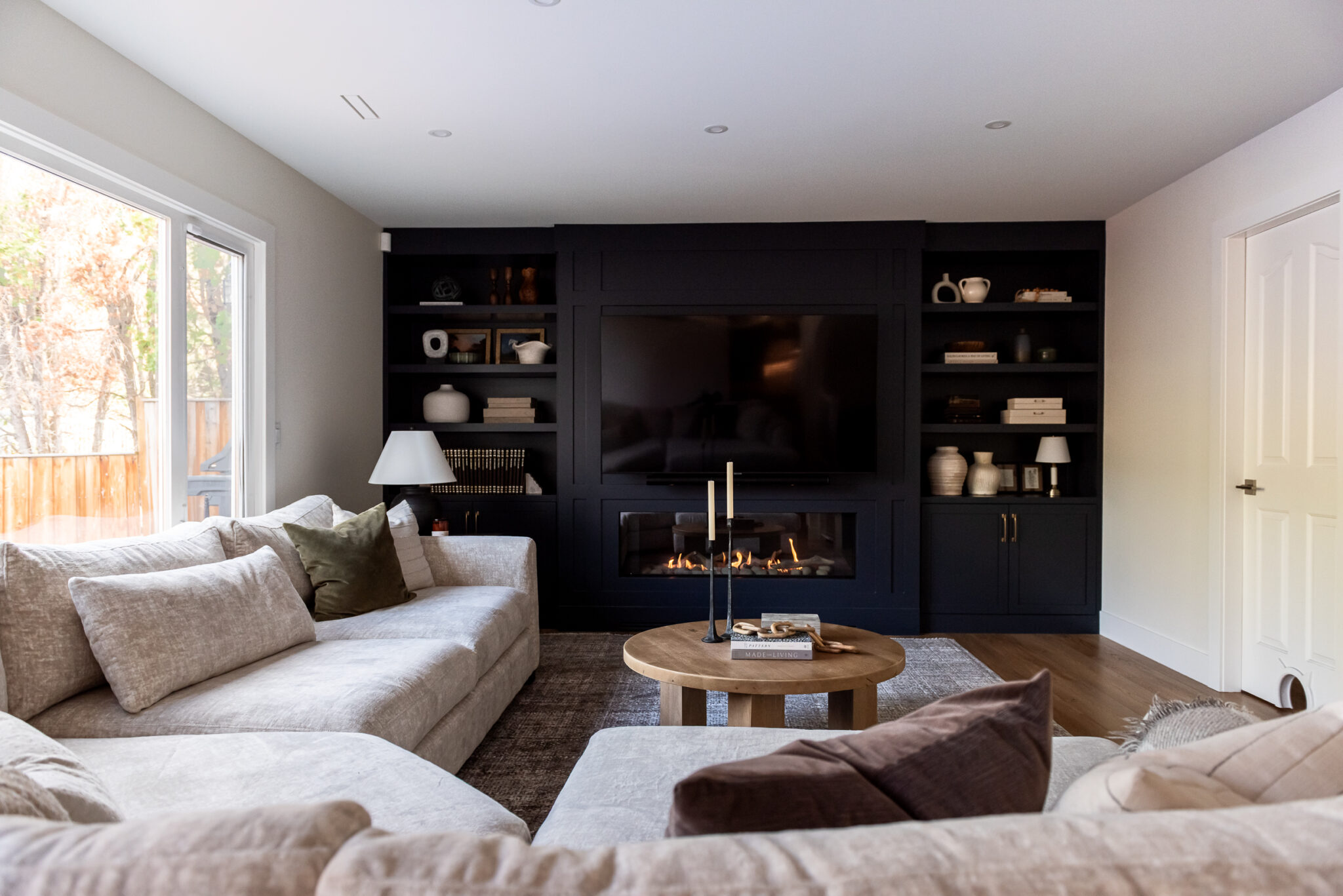 After photo of modern living room with linear fireplace and custom built-in cabinetry