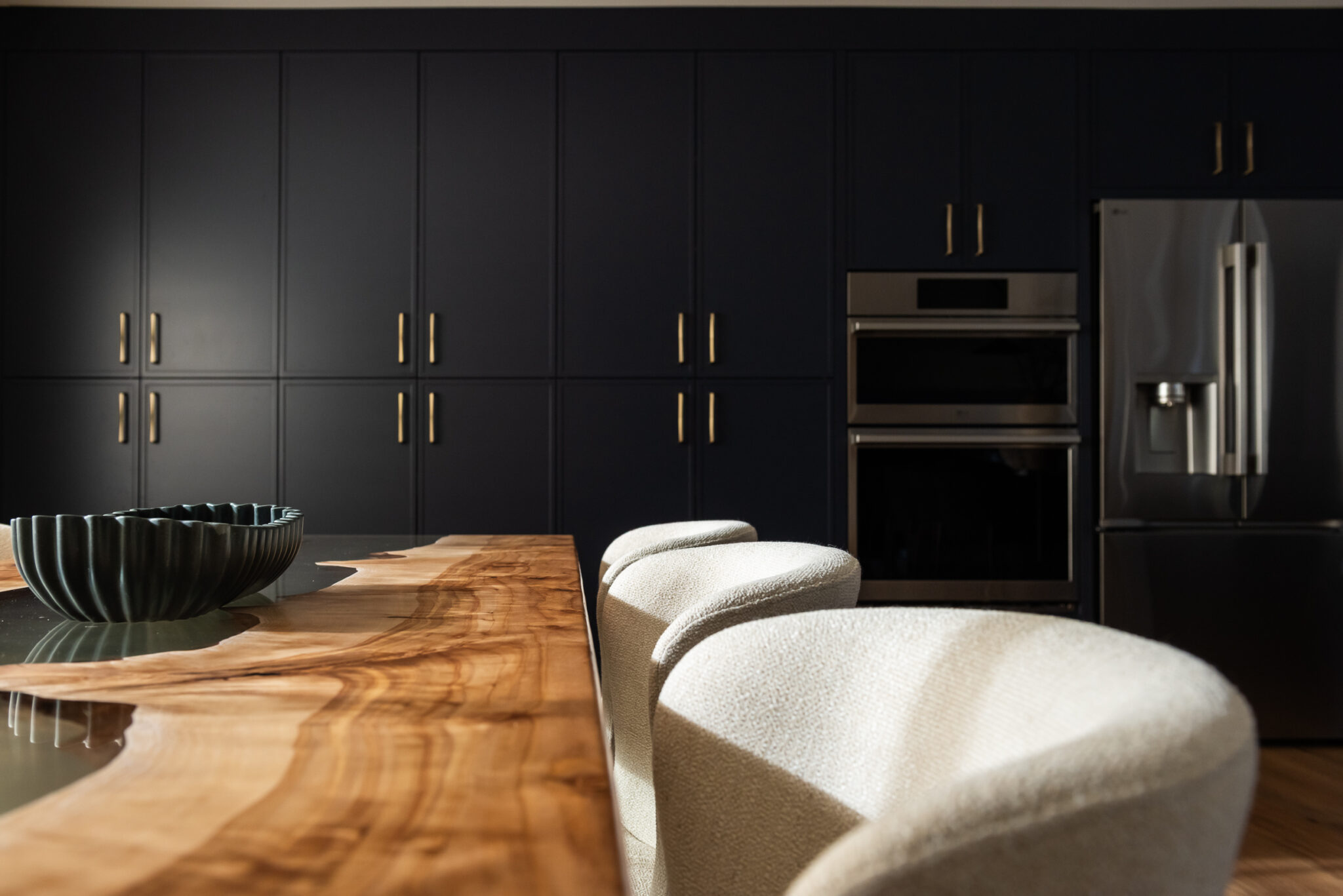 Custom navy pantry wall with floor-to-ceiling cabinetry for high-function family kitchen storage