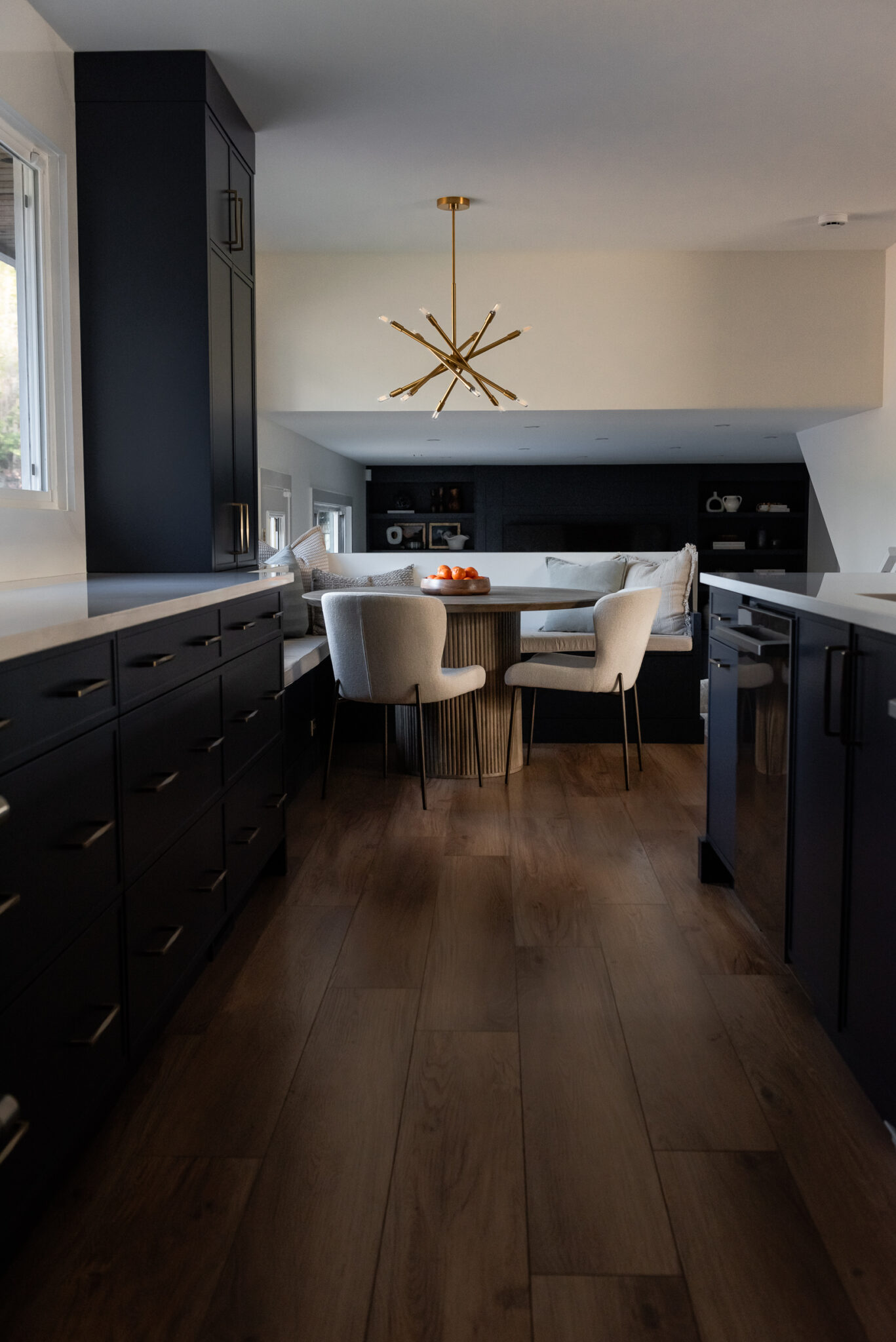 Cozy built-in breakfast nook with cushions and window view in updated kitchen
