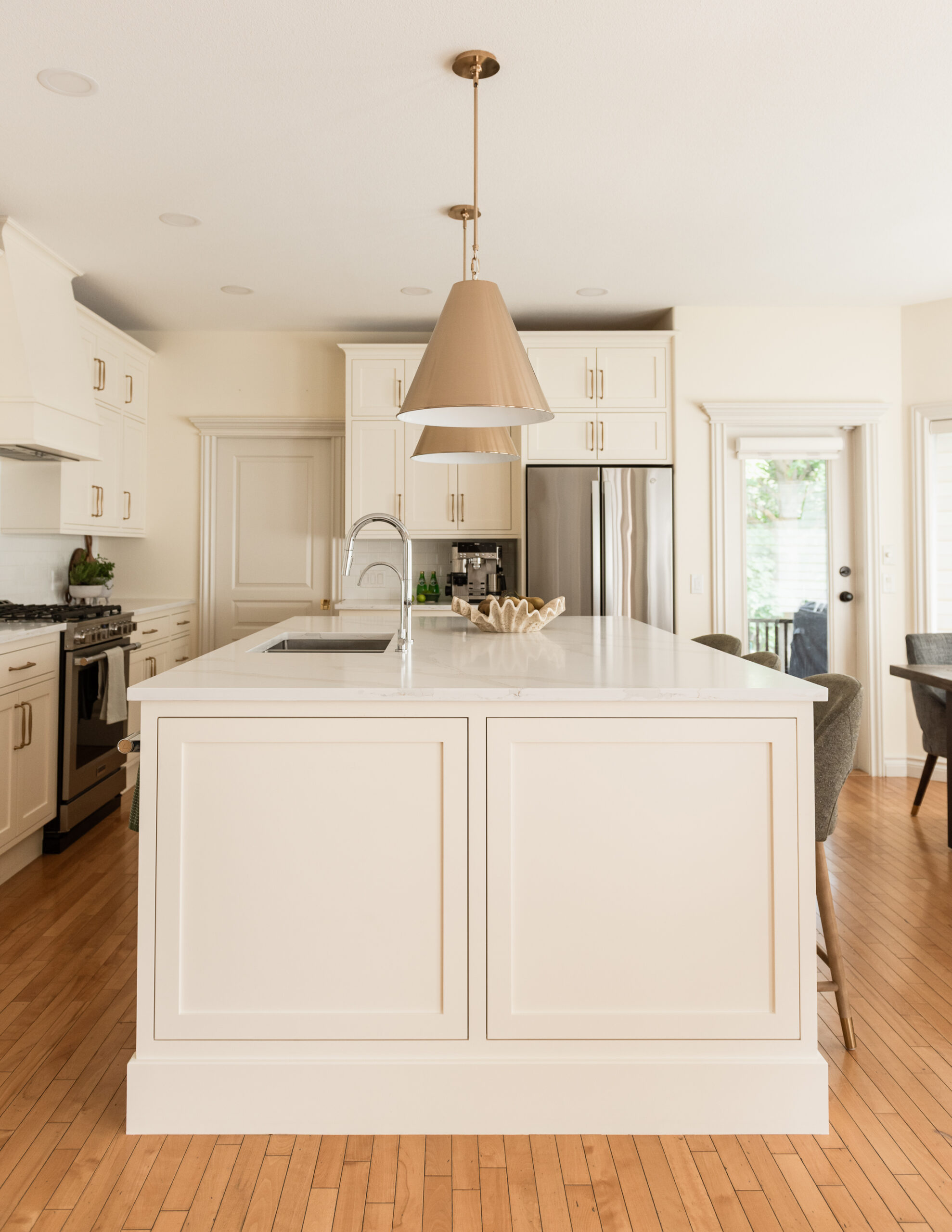 Custom oversized kitchen island replacing a former L-shaped layout to improve flow, seating, and functionality.