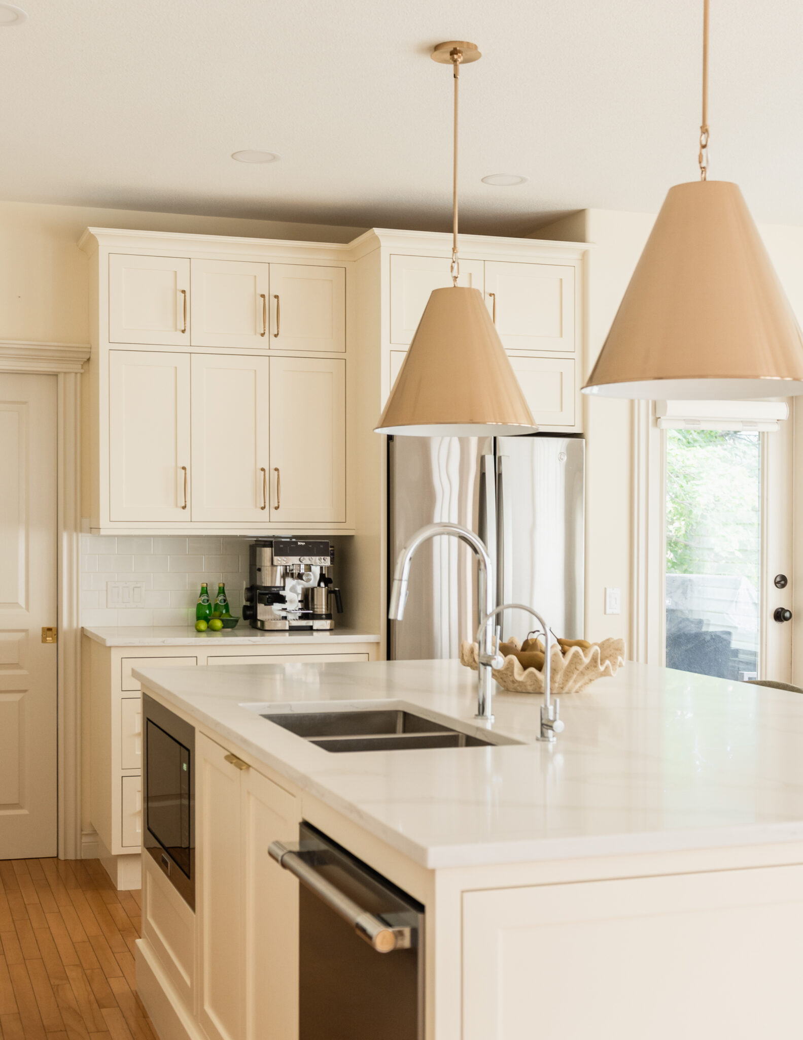 Custom oversized kitchen island replacing a former L-shaped layout to improve flow, seating, and functionality.