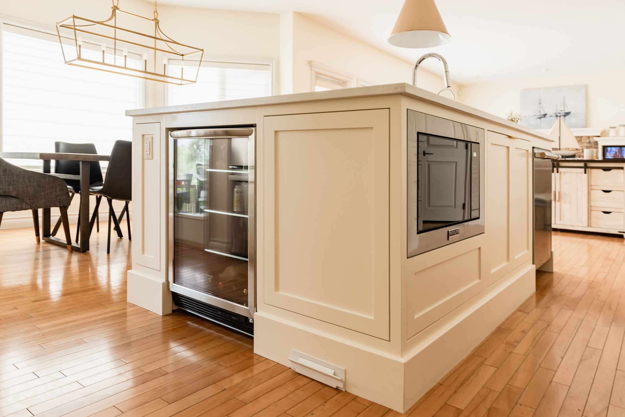 Custom oversized kitchen island replacing a former L-shaped layout to improve flow, seating, and functionality.