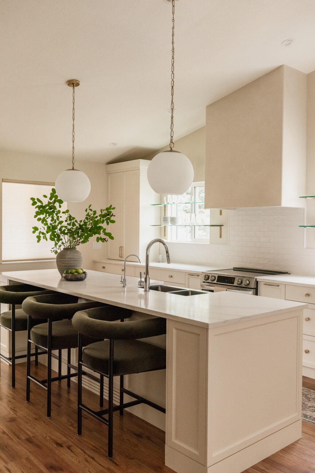 Kelowna kitchen renovation with glass shelves over windows and statement plaster hood