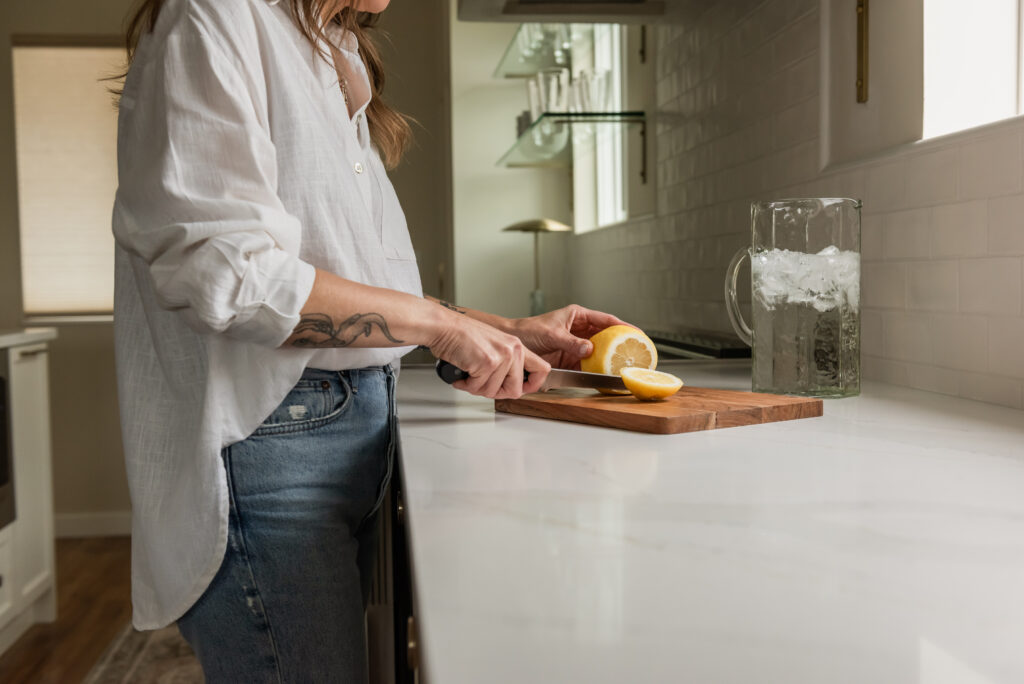 Couple cooking together in a bright open concept white kitchen renovation