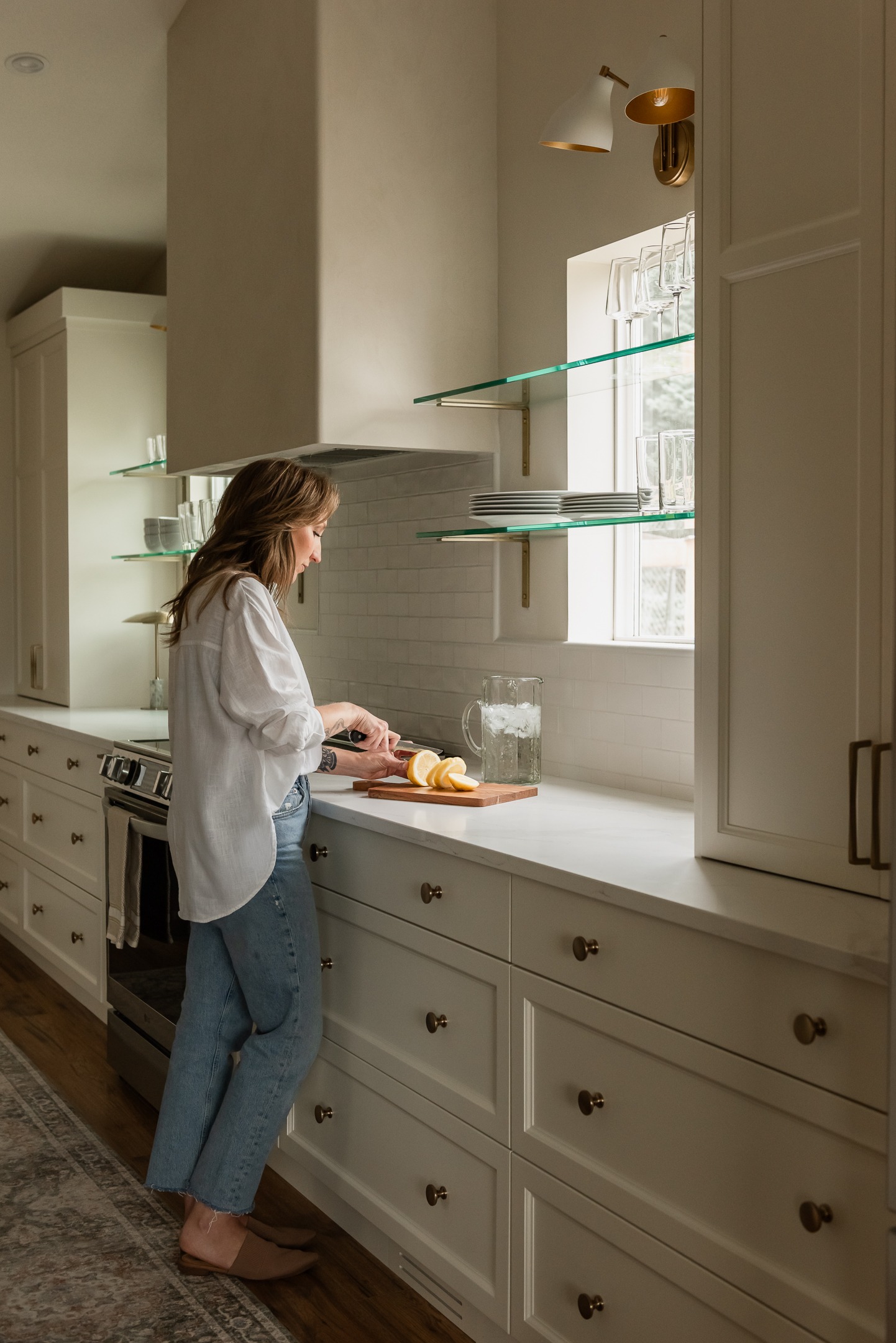 Couple cooking together in a bright open concept white kitchen renovation