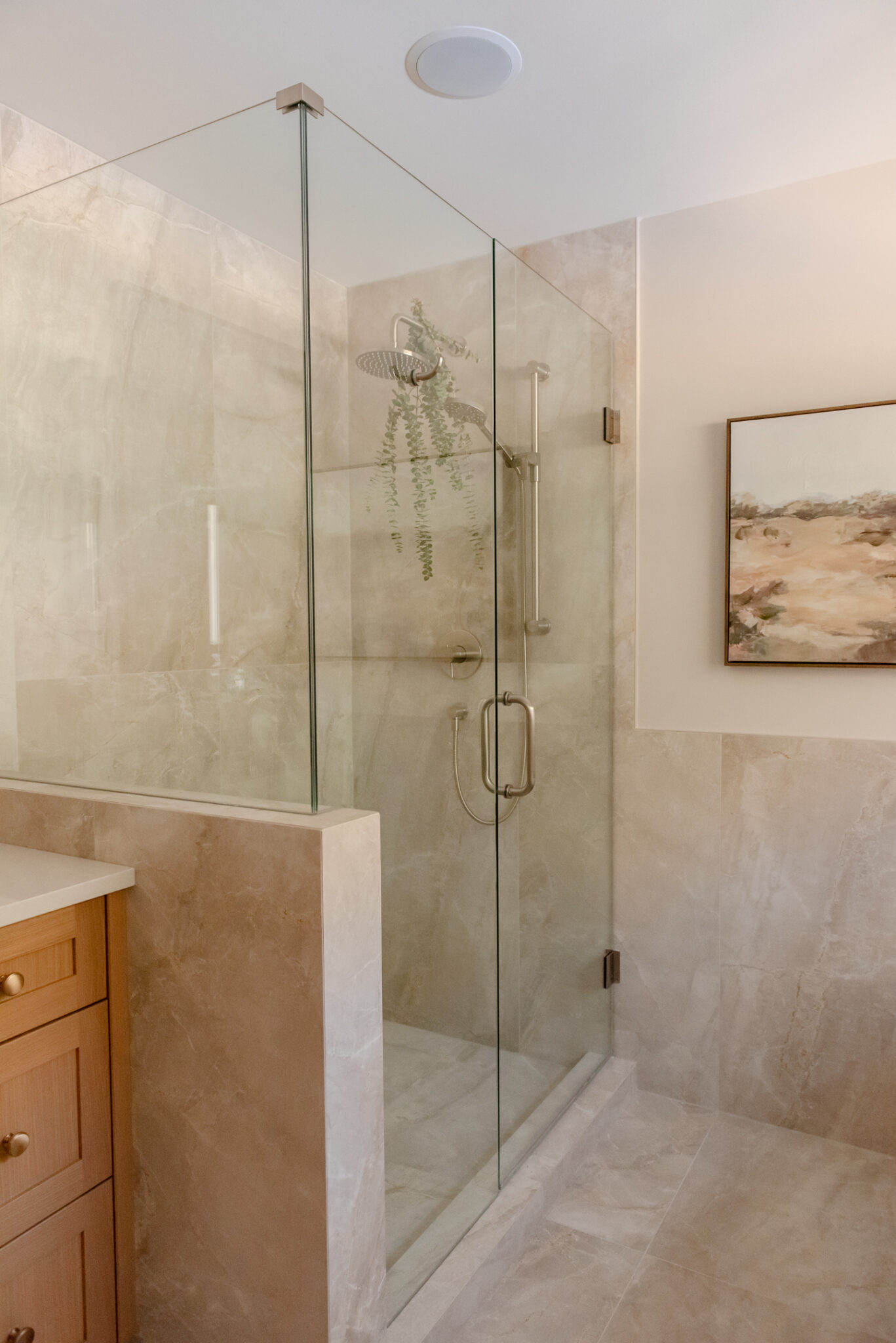 Mitred tile corners and special order schluter that match the tile make this ensuite feel curated