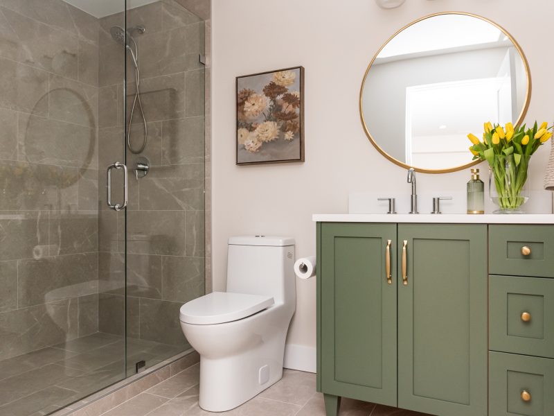 basement bathroom with green vanity and walk in shower