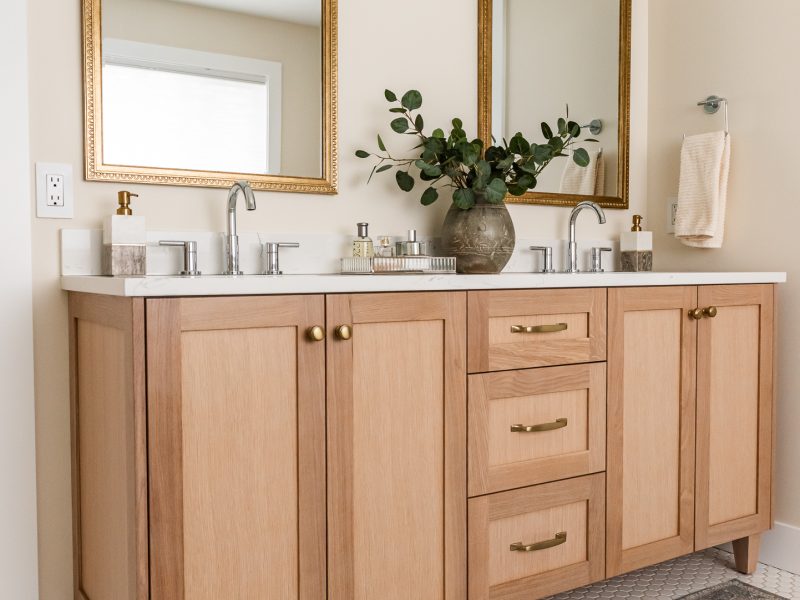 transitional ensuite with white oak vanity, vintage mirrors and styling