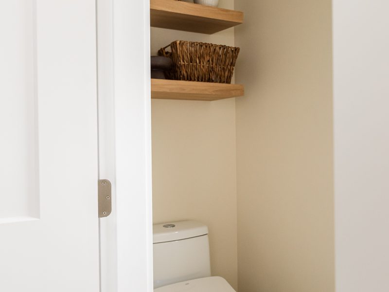 water closet with bidet and shelves