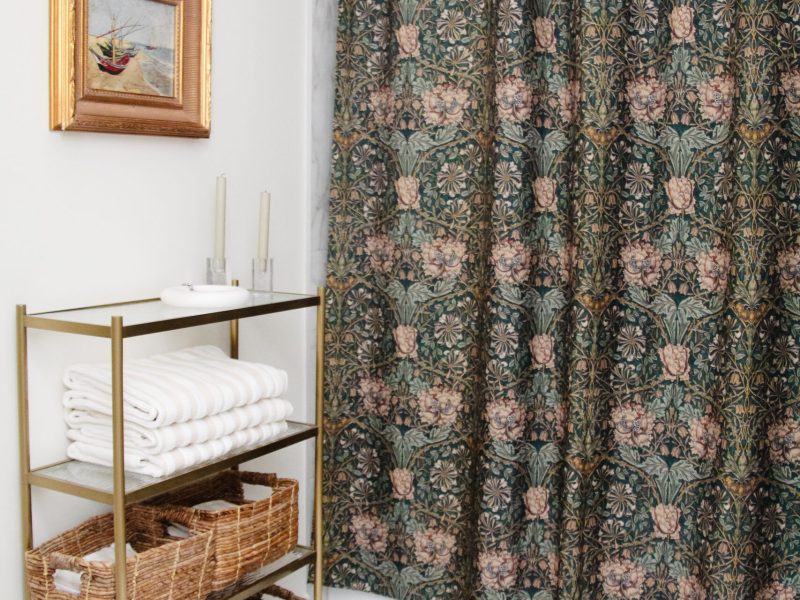 contemporary kids bathroom with green shower curtain and gold accents