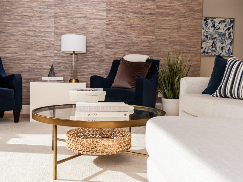 Transitional living room glass coffee table styling grasscloth wallpaper