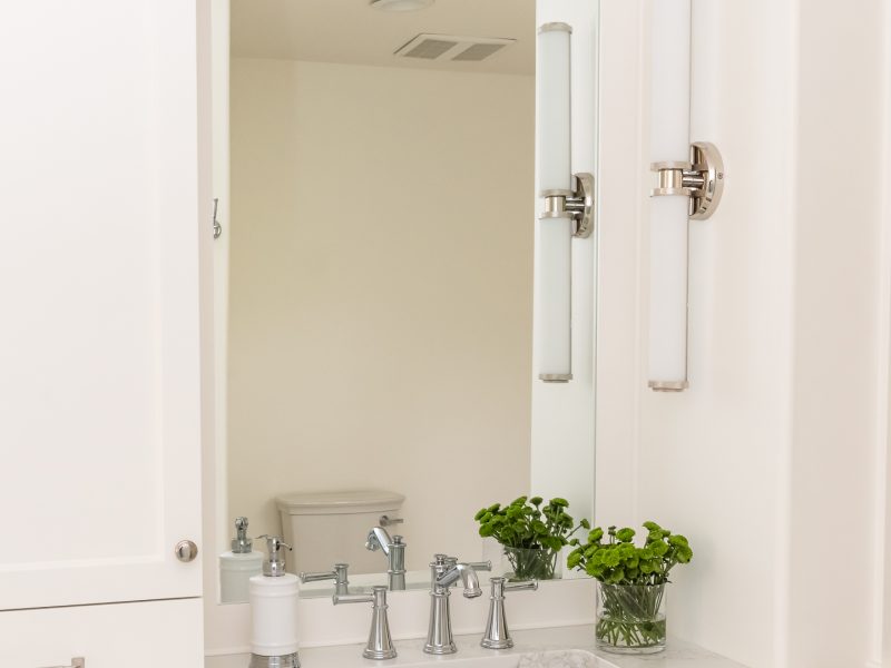Traditional white vanity with nickel scone and vanity tower