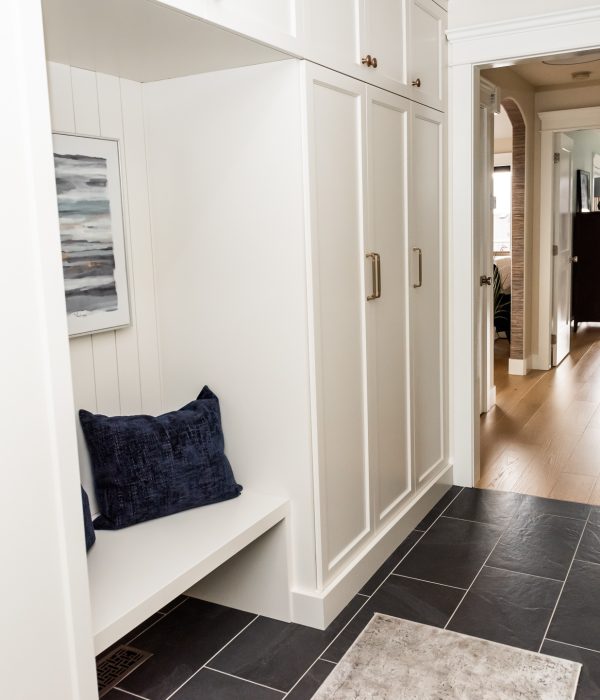 Cream mudroom cabinetry shiplap seating nook