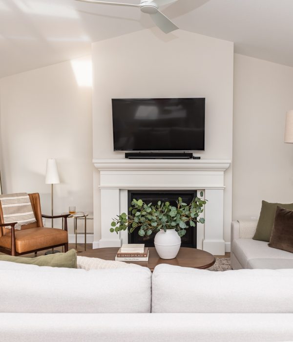 transitional living room cast stone fireplace, floor mirror